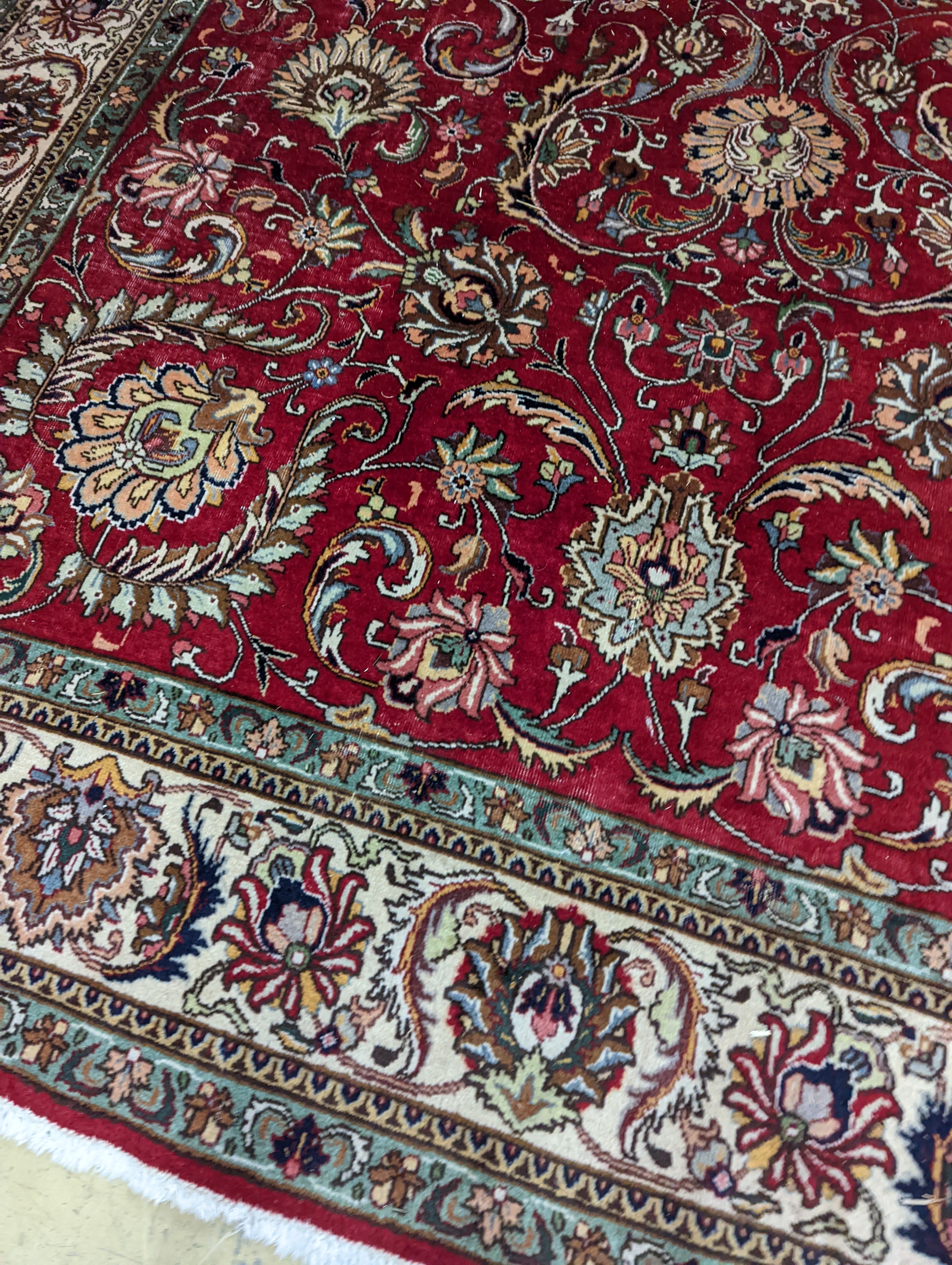 A Tabriz red ground carpet, 400 x 290cm